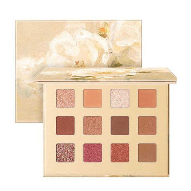 Makeup palette with various shades of eyeshadow in a decorative box with floral design